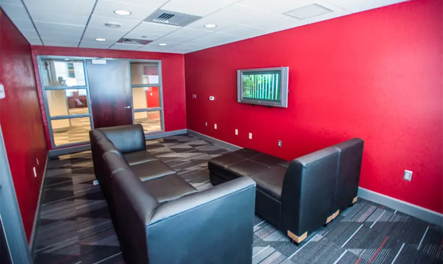 Bryant hall common area with couches and a tv